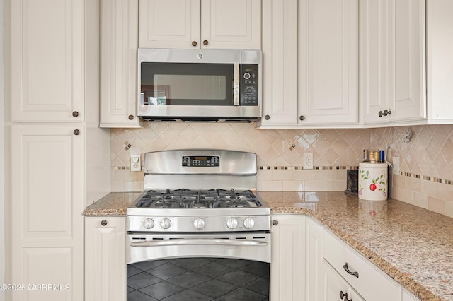 3 Dublin Ln, Hazlet, NJ 07730 - kitchen featuring appliances with stainless steel finishes, decorative backsplash, light stone countertops, white cabinets, and tile patterned floors