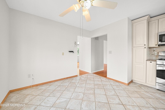 3 Dublin Ln, Hazlet, NJ 07730 - kitchen with stainless steel microwave, white range, ceiling fan, light tile patterned floors, and decorative backsplash