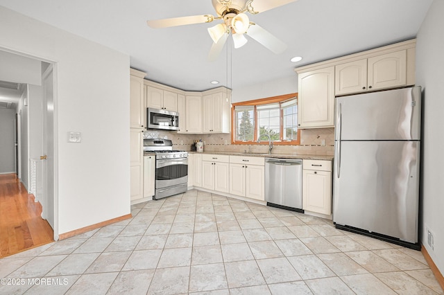 3 Dublin Ln, Hazlet, NJ 07730 - kitchen featuring stainless steel appliances, cream cabinetry, decorative backsplash, and recessed lighting