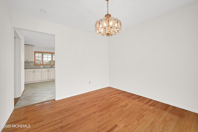 3 Dublin Ln, Hazlet, NJ 07730 - unfurnished room featuring a chandelier and light wood-type flooring