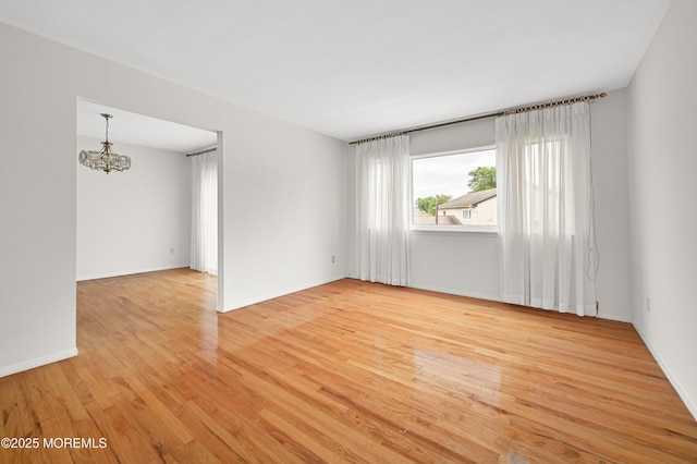 3 Dublin Ln, Hazlet, NJ 07730 - unfurnished room featuring a chandelier and light wood-style floors