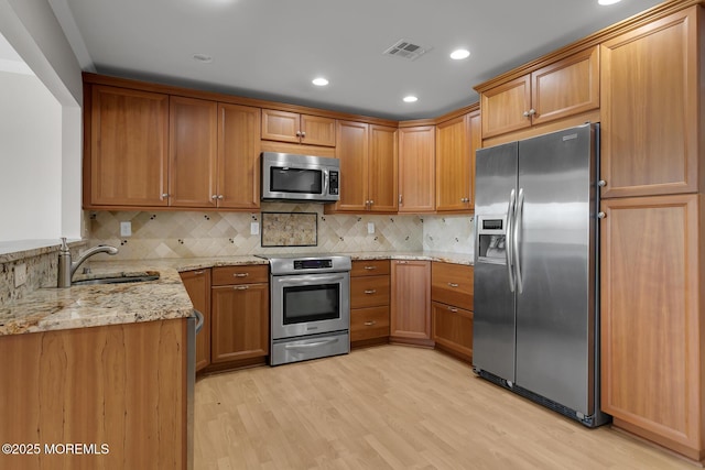 52 Kettle Creek Dr, Brick, NJ 08723 - kitchen featuring stainless steel appliances, light stone countertops, light wood-type flooring, recessed lighting, and tasteful backsplash