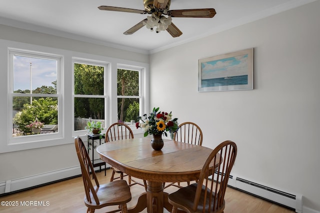 52 Kettle Creek Dr, Brick, NJ 08723 - dining area featuring baseboard heating, light wood-style flooring, a ceiling fan, and crown molding