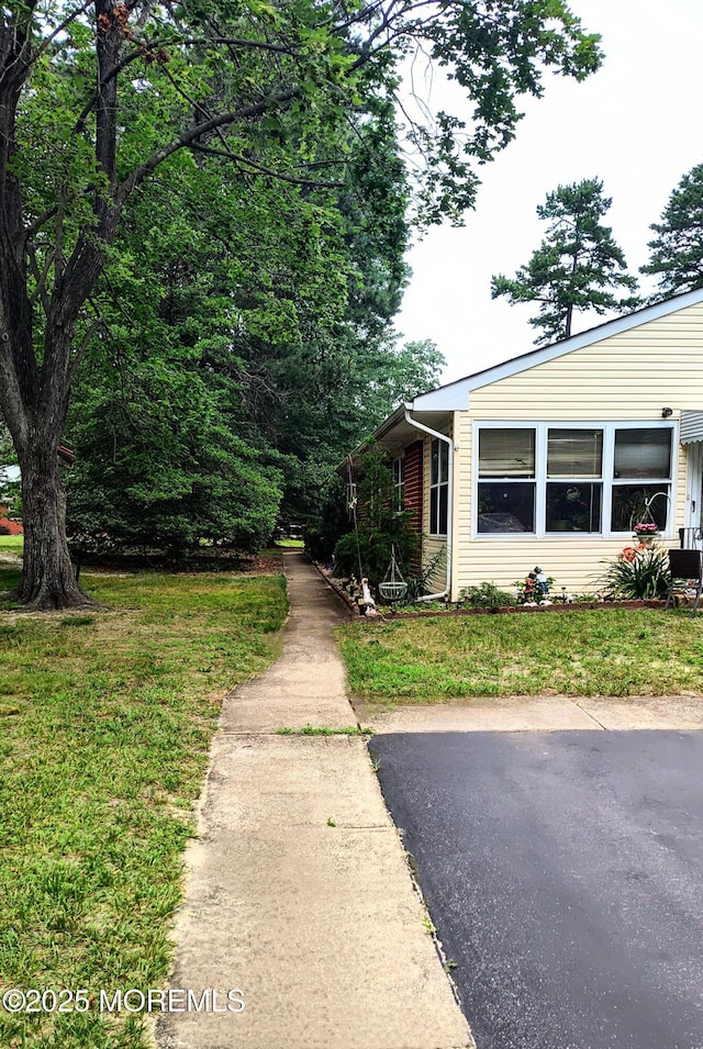 4 Snowberry Ln Unit D, Whiting, NJ 08759 - view of property exterior with a yard
