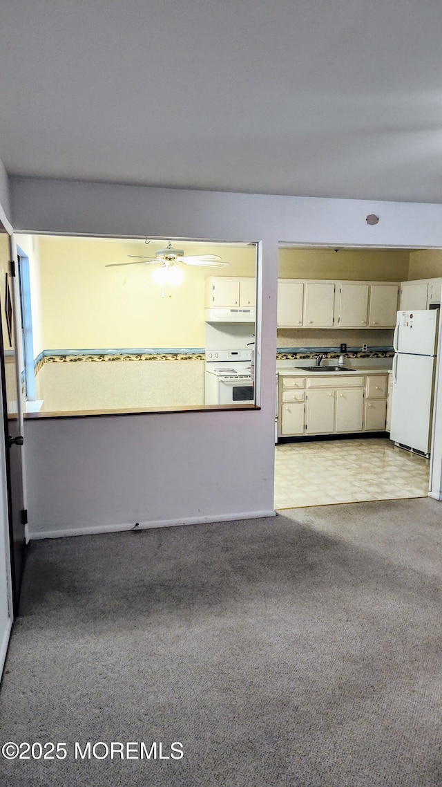 4 Snowberry Ln Unit D, Whiting, NJ 08759 - kitchen with white appliances, light carpet, under cabinet range hood, and a ceiling fan