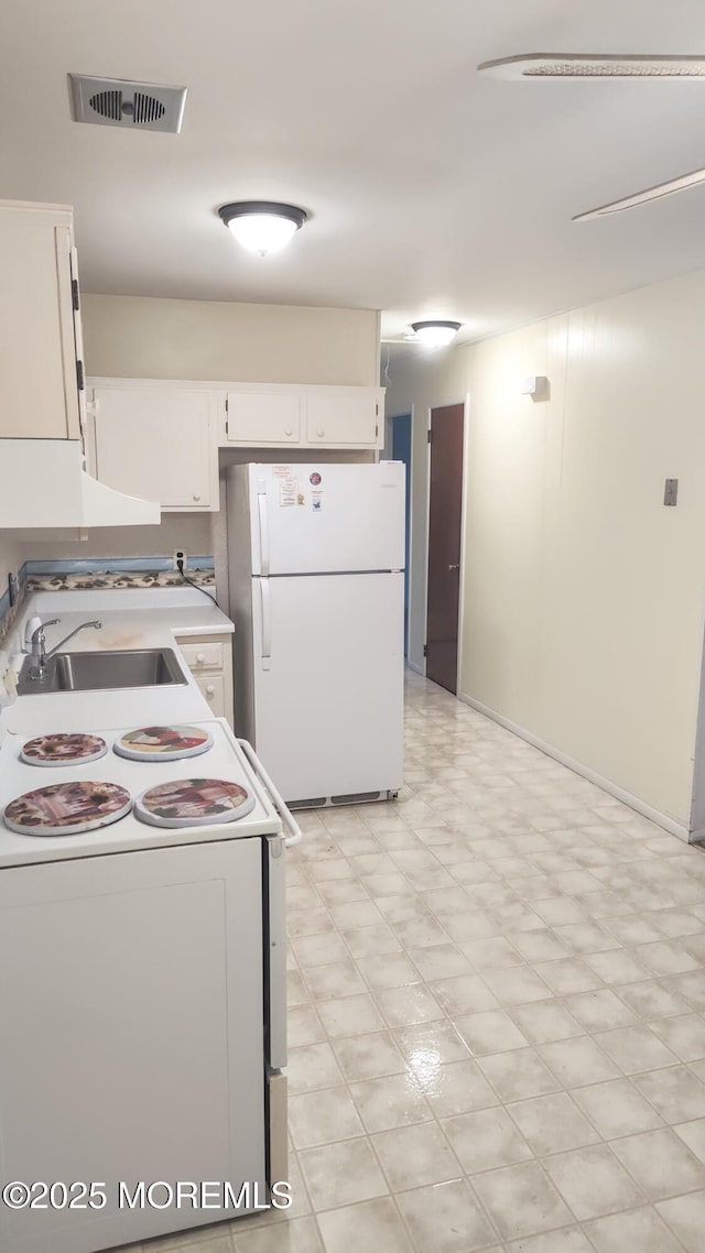 4 Snowberry Ln Unit D, Whiting, NJ 08759 - kitchen with white appliances, light floors, white cabinets, light countertops, and range hood