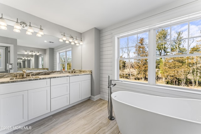837 Naryshkin Way, Toms River, NJ 08753 - bathroom featuring double vanity, a freestanding bath, a chandelier, and wood finished floors