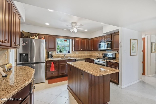58 Old Bridge Dr, Howell, NJ 07731 - kitchen featuring stainless steel appliances, backsplash, ceiling fan, light stone counters, and a kitchen island