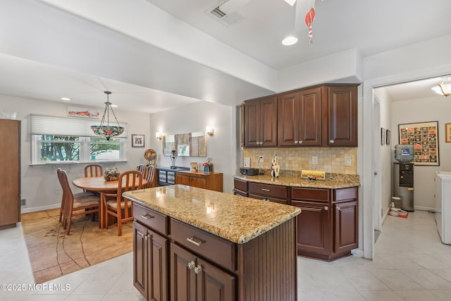 58 Old Bridge Dr, Howell, NJ 07731 - kitchen with decorative backsplash, light tile patterned flooring, light stone counters, a kitchen island, and pendant lighting