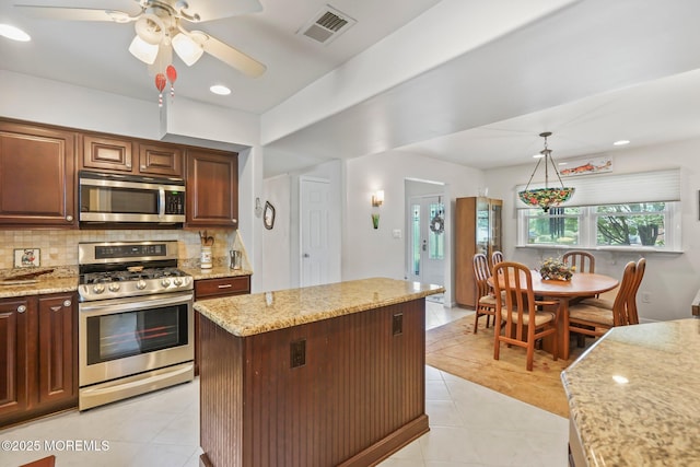 58 Old Bridge Dr, Howell, NJ 07731 - kitchen with stainless steel appliances, tasteful backsplash, light stone countertops, light tile patterned flooring, and recessed lighting