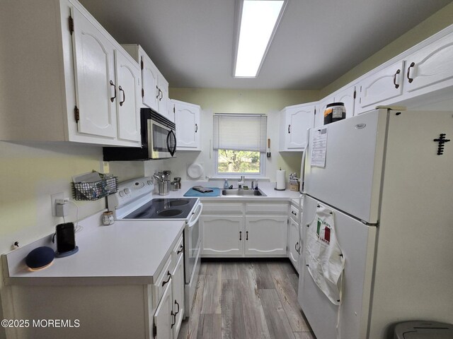 5 Potomac Ln Unit D, Whiting, NJ 08759 - kitchen featuring white appliances, wood finished floors, white cabinetry, and light countertops
