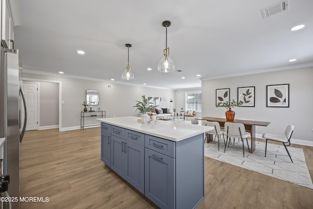 12 Weston Ct, Marlboro, NJ 07746 - kitchen featuring recessed lighting, ornamental molding, light countertops, pendant lighting, and light wood-style flooring