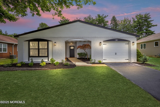 12 Weston Ct, Marlboro, NJ 07746 - ranch-style house with driveway, brick siding, a lawn, and an attached garage