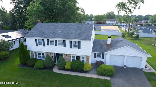 20 Kenwood Ln, Old Bridge, NJ 08857 - view of front of house with a chimney, a garage, stone siding, and asphalt driveway