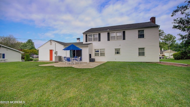 20 Kenwood Ln, Old Bridge, NJ 08857 - rear view of house with a chimney, a patio area, and a yard