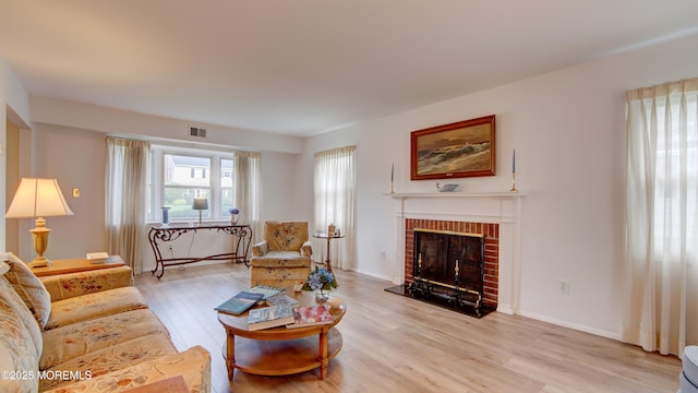 20 Kenwood Ln, Old Bridge, NJ 08857 - living room with light wood-style flooring and a brick fireplace