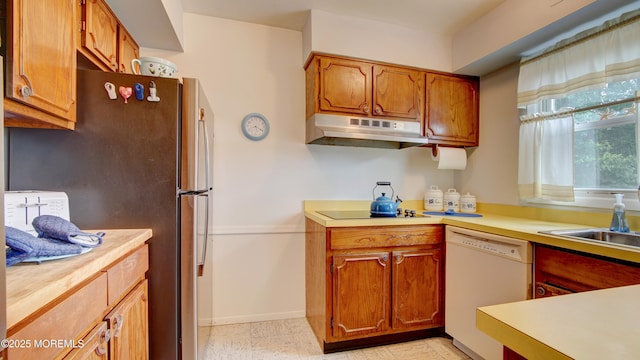 20 Kenwood Ln, Old Bridge, NJ 08857 - kitchen featuring under cabinet range hood, dishwasher, freestanding refrigerator, light countertops, and brown cabinets