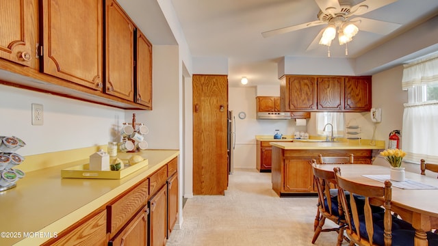 20 Kenwood Ln, Old Bridge, NJ 08857 - kitchen with light countertops, brown cabinets, a ceiling fan, and under cabinet range hood