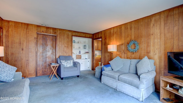 20 Kenwood Ln, Old Bridge, NJ 08857 - living room with wood walls, carpet, and built in shelves