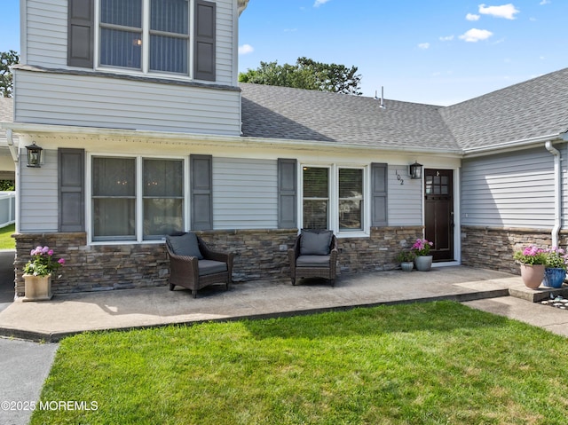 102 Oak Glen Rd, Toms River, NJ 08753 - back of property featuring stone siding, a yard, roof with shingles, and a patio area