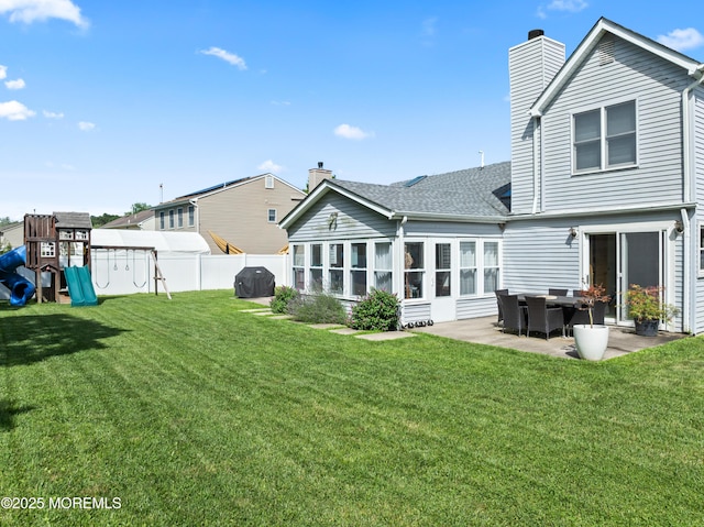102 Oak Glen Rd, Toms River, NJ 08753 - rear view of house featuring a chimney, a patio, roof with shingles, and a playground