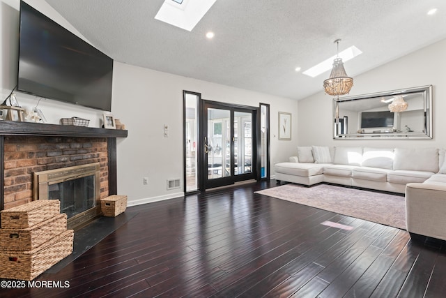 102 Oak Glen Rd, Toms River, NJ 08753 - living room featuring a skylight, vaulted ceiling, a fireplace, wood finished floors, and recessed lighting