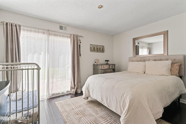 102 Oak Glen Rd, Toms River, NJ 08753 - bedroom with wood finished floors and a textured ceiling