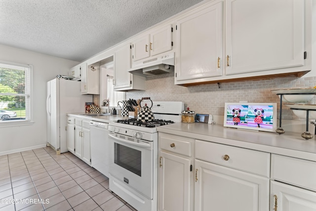 102 Oak Glen Rd, Toms River, NJ 08753 - kitchen with under cabinet range hood, white appliances, light countertops, backsplash, and white cabinetry