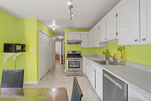 7 Warbler Rd, Marlboro, NJ 07746 - kitchen featuring stainless steel appliances, under cabinet range hood, white cabinets, light countertops, and rail lighting