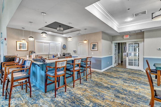 43 Westport Dr, Barnegat, NJ 08005 - kitchen with a tray ceiling, stainless steel microwave, ornamental molding, carpet flooring, and hanging light fixtures