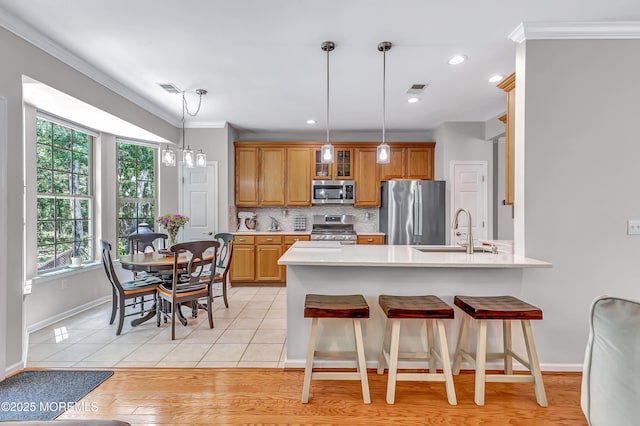 43 Westport Dr, Barnegat, NJ 08005 - kitchen with stainless steel appliances, a peninsula, crown molding, light countertops, and backsplash