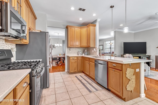 43 Westport Dr, Barnegat, NJ 08005 - kitchen featuring appliances with stainless steel finishes, crown molding, a chandelier, a peninsula, and light tile patterned flooring