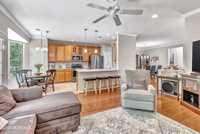 43 Westport Dr, Barnegat, NJ 08005 - living room featuring a chandelier, ornamental molding, ceiling fan, recessed lighting, and light wood-style flooring