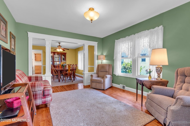 833 Lincoln St, Red Bank, NJ 07701 - living area with decorative columns, wood finished floors, and ceiling fan