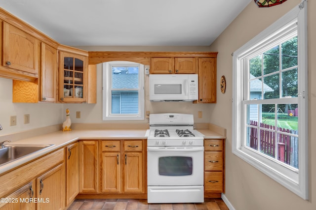 833 Lincoln St, Red Bank, NJ 07701 - kitchen featuring white appliances, glass insert cabinets, and light countertops