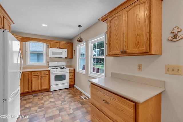 833 Lincoln St, Red Bank, NJ 07701 - kitchen with white appliances, plenty of natural light, light countertops, recessed lighting, and hanging light fixtures