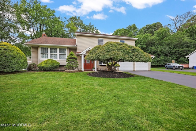3 Sudbury Rd, Morganville, NJ 07751 - split level home with asphalt driveway, a chimney, and a front yard