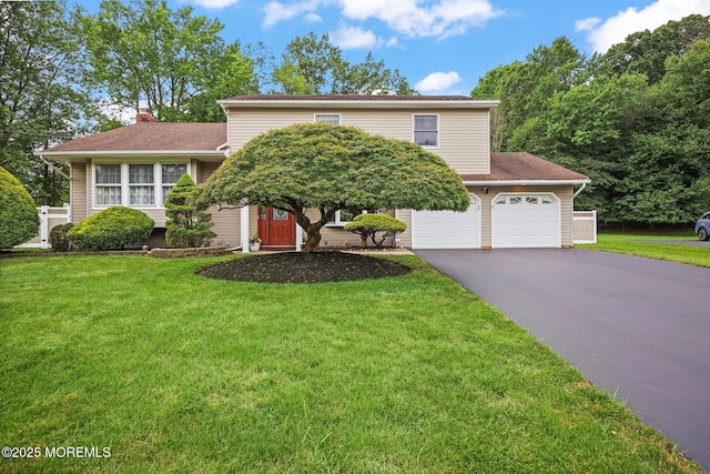 3 Sudbury Rd, Morganville, NJ 07751 - view of front of property with asphalt driveway, a front lawn, a chimney, and roof with shingles