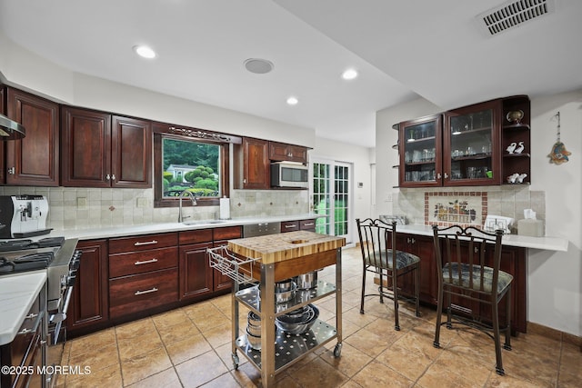 3 Sudbury Rd, Morganville, NJ 07751 - kitchen with light countertops, decorative backsplash, white microwave, recessed lighting, and glass insert cabinets