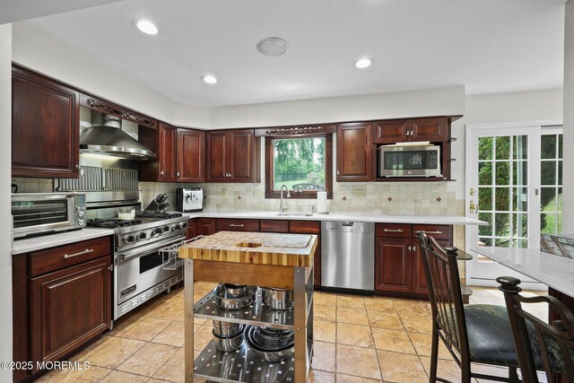 3 Sudbury Rd, Morganville, NJ 07751 - kitchen featuring appliances with stainless steel finishes, wall chimney range hood, tasteful backsplash, and recessed lighting