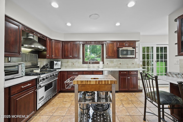 3 Sudbury Rd, Morganville, NJ 07751 - kitchen featuring appliances with stainless steel finishes, wall chimney exhaust hood, tasteful backsplash, recessed lighting, and light tile patterned floors