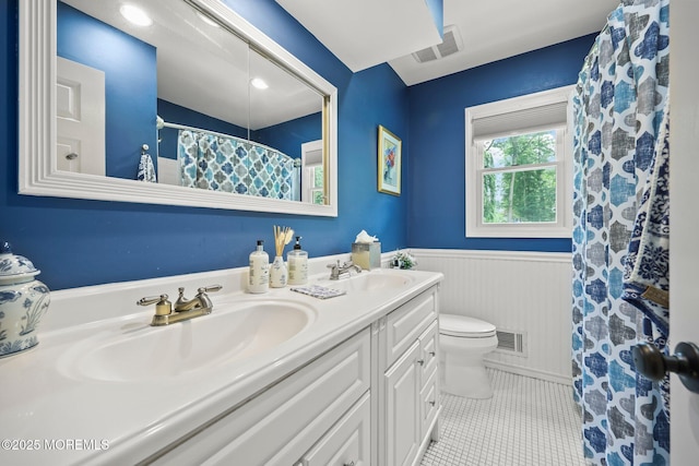 3 Sudbury Rd, Morganville, NJ 07751 - bathroom featuring double vanity, a wainscoted wall, tile patterned floors, and a shower with curtain