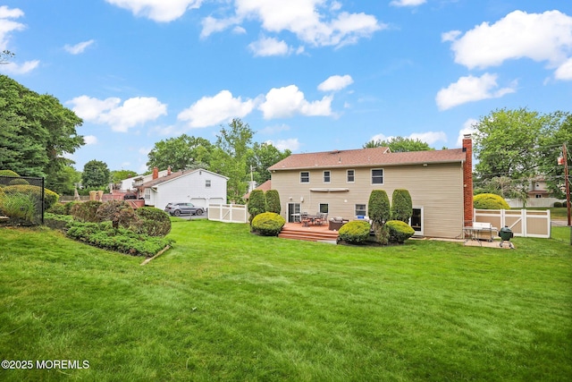 3 Sudbury Rd, Morganville, NJ 07751 - back of house with a chimney, a fenced backyard, and a wooden deck