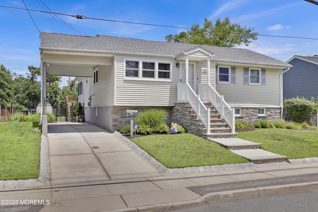 405 Orange Ave, Union Beach, NJ 07735 - view of front of property with driveway, a front lawn, a shingled roof, and stone siding