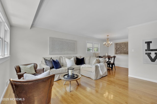 405 Orange Ave, Union Beach, NJ 07735 - living room with light wood-style flooring, a chandelier, and ornamental molding