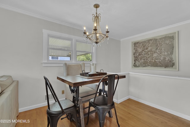 405 Orange Ave, Union Beach, NJ 07735 - dining space featuring a chandelier, wood finished floors, and ornamental molding