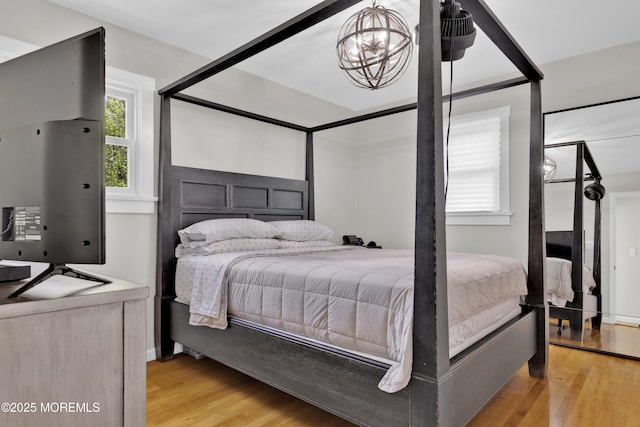 405 Orange Ave, Union Beach, NJ 07735 - bedroom with light wood-style floors and a chandelier