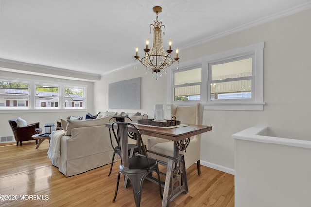 405 Orange Ave, Union Beach, NJ 07735 - dining area featuring ornamental molding, a chandelier, and light wood-type flooring