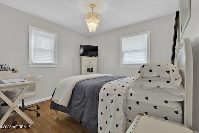 405 Orange Ave, Union Beach, NJ 07735 - bedroom featuring wood finished floors and a chandelier