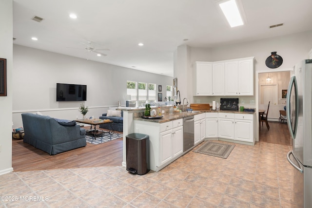 1 Silverspring Dr, Lakewood, NJ 08701 - kitchen with open floor plan, appliances with stainless steel finishes, a peninsula, white cabinets, and a ceiling fan
